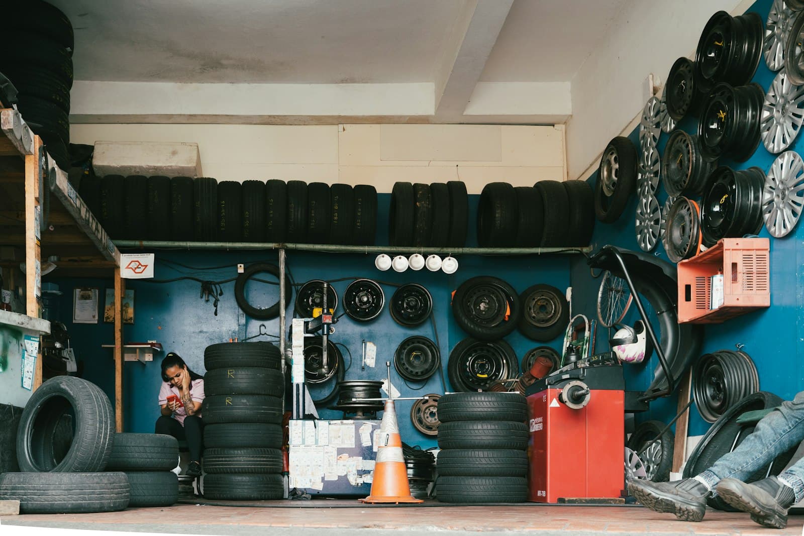 A tire shop wall stacked with tires and wheels